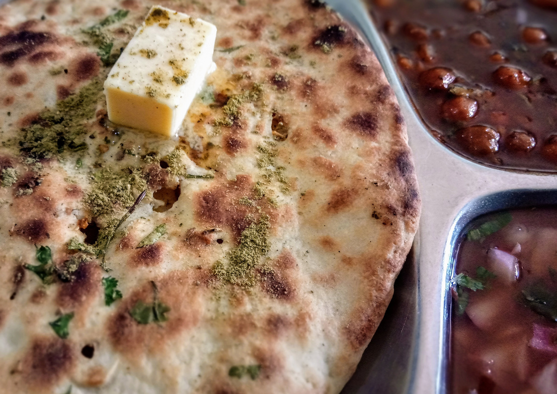 Indian panjabi famous dish named Aalu kulcha served with butter